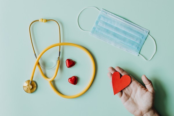 Stethoscope, mask and paper heart in a person's hand, Photo by Karolina Grabowska