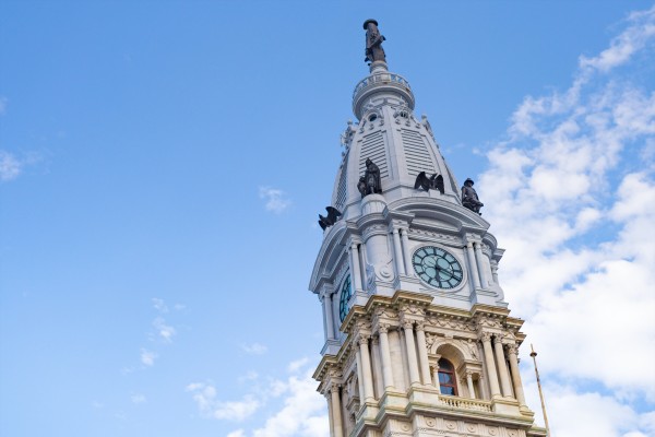 Top portion of Philadelphia City Hall against a blue sky