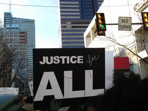 "Justice for All" poster at 2017 March for Humanity in Philadelphia, 7beachbum from Tsuruoka, Japan, CC BY 2.0 <https://creativecommons.org/licenses/by/2.0>, via Wikimedia Commons