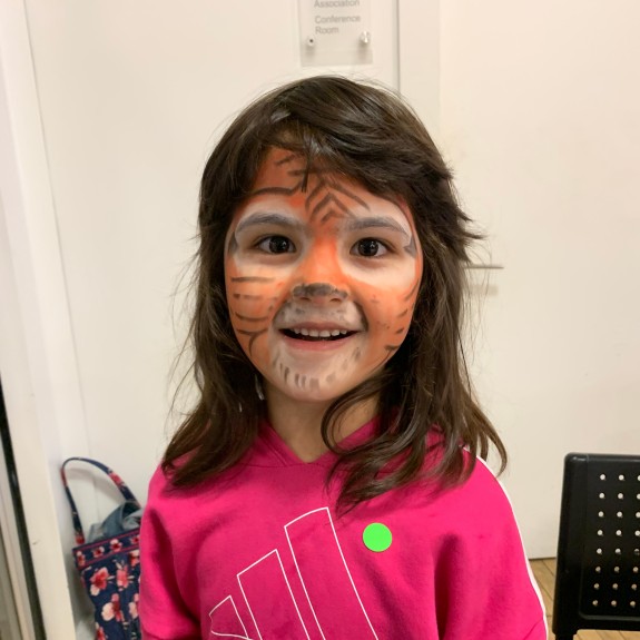 Child of NSC client gets her face painted as a tiger at NSC Fall Festival 2022