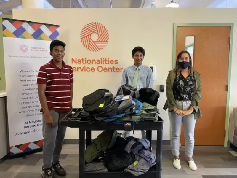 Advaith Kollipara, left, and Daniel Adibi, right, donate their school supply bundles to the Nationalities Service Center.