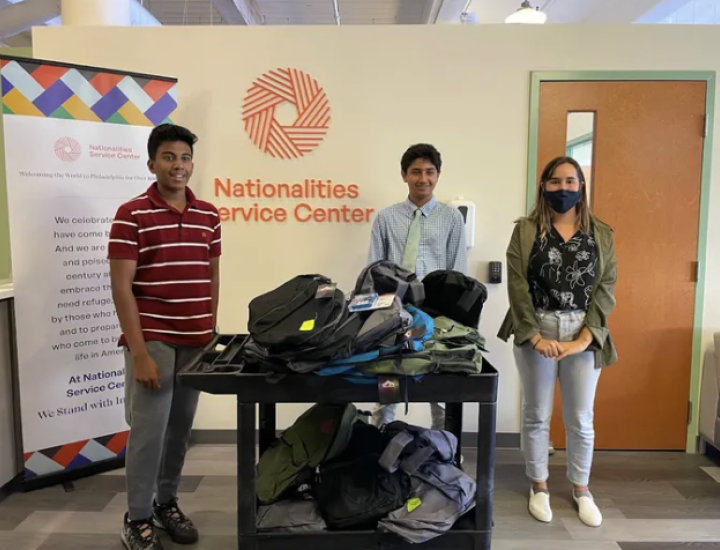 Advaith Kollipara, left, and Daniel Adibi, right, donate their school supply bundles to the Nationalities Service Center.